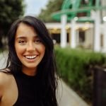 Captivating portrait of a cheerful young woman outdoors in Tbilisi, showcasing natural beauty.